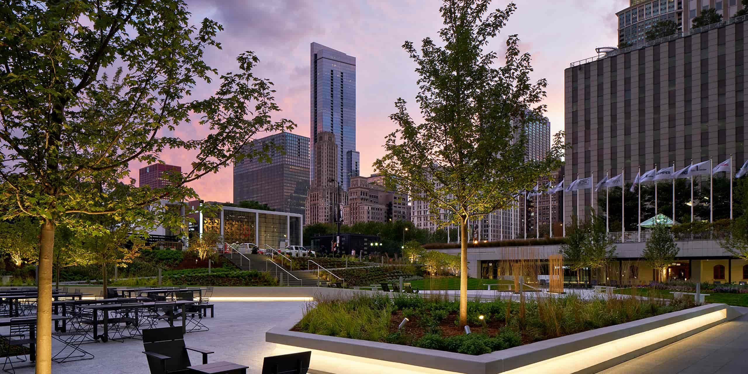 The Aon Complex has a sloping lawn, plantings, and sound sculptures