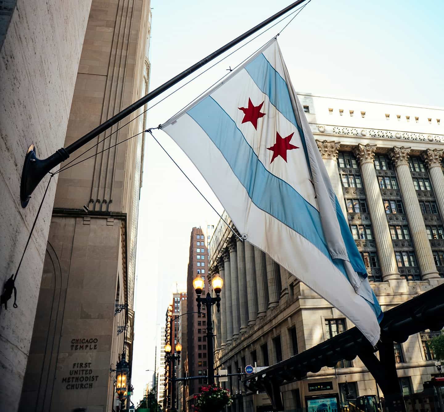 The Chicago Flag with building of downtown in the background